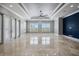 Spacious living area with shuttered windows, marble floors, high ceilings, and a modern ceiling fan at 3440 Sw 66Th St, Ocala, FL 34476