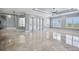 Bright and airy living space with marble floors, access to multiple rooms, shuttered windows, and neutral wall color at 3440 Sw 66Th St, Ocala, FL 34476