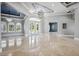 Bright living room with high ceilings, elegant chandeliers, marble floors, arched windows, and double glass doors to the exterior at 3440 Sw 66Th St, Ocala, FL 34476