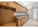 Well-organized mudroom with custom cabinets, coat hooks, bench seating, and tile flooring, perfect for storage at 3440 Sw 66Th St, Ocala, FL 34476