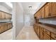 Another view of a functional mudroom with custom wood cabinetry, counters, and a doorway to a hallway at 3440 Sw 66Th St, Ocala, FL 34476