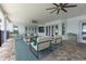 Comfortable outdoor patio with seating, rug, and ceiling fans at 3440 Sw 66Th St, Ocala, FL 34476