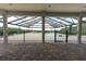 Covered patio with brick flooring, white columns, and a screened pool view in the background at 3440 Sw 66Th St, Ocala, FL 34476