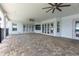 Expansive outdoor patio with brick flooring, ceiling fans, and multiple doors leading to the interior at 3440 Sw 66Th St, Ocala, FL 34476
