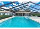 Stunning pool area with a spa, sun shelf, waterfall feature, and screened enclosure for ultimate relaxation at 3440 Sw 66Th St, Ocala, FL 34476