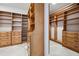 Walk-in closet features custom wood shelving and drawers providing ample storage space at 3440 Sw 66Th St, Ocala, FL 34476