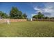 Spacious backyard with lush green grass, a wooden fence, and a storage shed for outdoor essentials at 3645 Sw 151St Ct, Ocala, FL 34481