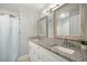 Bathroom featuring a granite countertop, dual sinks, wood-framed mirrors, and shower with a white curtain at 3645 Sw 151St Ct, Ocala, FL 34481