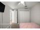 Comfortable bedroom featuring a crib, pink bedding, a ceiling fan, and closet at 3645 Sw 151St Ct, Ocala, FL 34481
