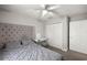 Comfortable bedroom featuring a tufted headboard, grey bedding, vanity, and a ceiling fan for added comfort at 3645 Sw 151St Ct, Ocala, FL 34481