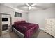 Bedroom with plush burgundy bed, ample natural light, and closet space at 3645 Sw 151St Ct, Ocala, FL 34481