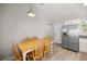 Eat-in kitchen area with stainless steel refrigerator and a wooden dining table at 3645 Sw 151St Ct, Ocala, FL 34481