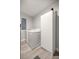 Functional laundry room with modern appliances, a large white cabinet, and sleek flooring at 3645 Sw 151St Ct, Ocala, FL 34481
