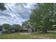 Large backyard with mature trees, a shed, and a swing set at 37 Oak Loop, Ocala, FL 34472