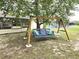 Relax on this backyard swing, a perfect spot for relaxation and enjoying the outdoors at 37 Oak Loop, Ocala, FL 34472