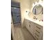 Bathroom with stylish vanity, sleek fixtures, and updated tiled shower behind a glass door at 37 Oak Loop, Ocala, FL 34472