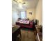 Bedroom with a ceiling fan, a large window, and a cozy bed with colorful quilt at 37 Oak Loop, Ocala, FL 34472