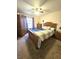 Bedroom with a wooden bed frame, ceiling fan, and a window with curtains at 37 Oak Loop, Ocala, FL 34472