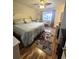 Comfortable bedroom with light hardwood flooring, ceiling fan, and a cozy sitting area at 37 Oak Loop, Ocala, FL 34472