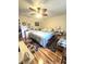 Comfortable bedroom with light hardwood flooring, ceiling fan, and a cozy sitting area at 37 Oak Loop, Ocala, FL 34472