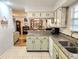 Open kitchen featuring granite countertops, modern appliances, and a view of the living area at 37 Oak Loop, Ocala, FL 34472