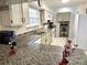 Bright kitchen featuring granite countertops, white cabinets, and modern appliances at 37 Oak Loop, Ocala, FL 34472
