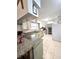 Bright kitchen with granite counters, tile floors and stainless steel appliances at 37 Oak Loop, Ocala, FL 34472