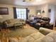 Cozy living room with hardwood floors, comfortable seating, and natural light at 37 Oak Loop, Ocala, FL 34472