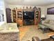 Comfortable living room with a large entertainment center, couches, and a decorative rug at 37 Oak Loop, Ocala, FL 34472
