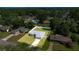 Drone-eye view displays the home set on a mature lot with a fenced backyard at 4325 Se 60Th St, Ocala, FL 34480