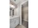 Bathroom vanity featuring granite countertop, mirror, and modern lighting fixture at 4325 Se 60Th St, Ocala, FL 34480