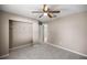 Bedroom with carpeted floors, a ceiling fan, and closet with white shelving at 4325 Se 60Th St, Ocala, FL 34480
