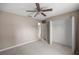 Bedroom featuring neutral walls, ceiling fan, open closet, and light carpet at 4325 Se 60Th St, Ocala, FL 34480