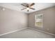 Bedroom with plush carpet, ceiling fan, and window with natural light at 4325 Se 60Th St, Ocala, FL 34480