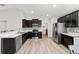 Modern kitchen with stainless steel appliances, dark cabinetry, and a stylish backsplash design at 4955 Se 89Th Place Rd, Ocala, FL 34480