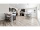 Modern kitchen with dark cabinets, stainless steel appliances, and an adjacent dining area with ample seating at 4955 Se 89Th Place Rd, Ocala, FL 34480