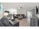 Comfortable living room with modern flooring and furnishings, open to the dining area and kitchen at 4955 Se 89Th Place Rd, Ocala, FL 34480