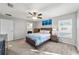 Comfortable main bedroom featuring a ceiling fan, a window and an ensuite bathroom entrance at 4955 Se 89Th Place Rd, Ocala, FL 34480