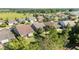 An aerial view highlighting a suburban neighborhood featuring houses with backyard fences and green landscaping near a golf course at 4970 Nw 35Th Lane Rd, Ocala, FL 34482