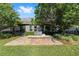 Brick patio with a stainless grill, set amongst the lush trees and grass of the backyard at 4970 Nw 35Th Lane Rd, Ocala, FL 34482