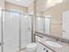Bathroom featuring a tiled shower with a glass door and vanity with a granite countertop at 4970 Nw 35Th Lane Rd, Ocala, FL 34482