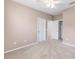 This is a secondary bedroom with carpeted floors and white doors leading to a closet and hallway at 4970 Nw 35Th Lane Rd, Ocala, FL 34482