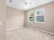 Neutral bedroom featuring carpeted floors, ceiling fan, and natural light from two windows at 4970 Nw 35Th Lane Rd, Ocala, FL 34482
