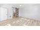 This bright bedroom features a sliding barn door, light walls and wood-look floors at 4970 Nw 35Th Lane Rd, Ocala, FL 34482