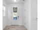 Bright foyer features tiled floors and a decorative glass front door at 4970 Nw 35Th Lane Rd, Ocala, FL 34482