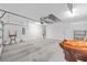 Spacious garage with a concrete floor, utility sink, and overhead storage racks at 4970 Nw 35Th Lane Rd, Ocala, FL 34482