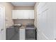 A well lit Laundry room with front load washer and dryer, cabinets, and a countertop at 4970 Nw 35Th Lane Rd, Ocala, FL 34482