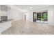 Open-concept living room with tile flooring, neutral walls, and large glass sliding doors at 4970 Nw 35Th Lane Rd, Ocala, FL 34482
