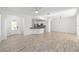 Spacious living room featuring tile flooring, a bar, and an open view to the kitchen at 4970 Nw 35Th Lane Rd, Ocala, FL 34482