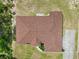 A bird's-eye view showcasing the roof and the well-maintained grounds, and convenient access to a concrete driveway at 4973 Sw 107Th Loop, Ocala, FL 34476